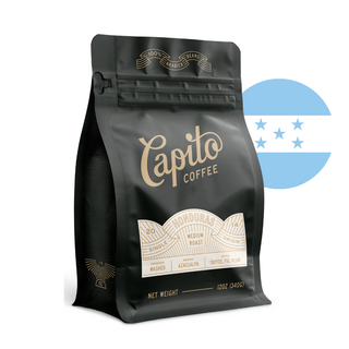  Black coffee bag labeled "Capito Coffee," featuring details such as "20 mesh," "Single Origin," "Honduras," "Medium Roast," "Washed," "Jazcuapa," "Toffee, Fig, Plum." The background includes a semi-transparent graphic of the Honduras flag.