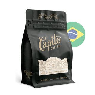  A black coffee bag labeled "Capito Coffee" with gold lettering. It specifies "Brazil," "Single Origin," and "Medium Roast," with tasting notes of "Honey, Almond, Dried Fruit." The net weight is 12oz (340g). The Brazilian flag is in the background.