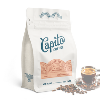 A white 12oz Capito Coffee "Case of Espresso Blend" bag sits next to a glass of Italian espresso and coffee beans, featuring small batch production, a light roast profile, and notes of sweet caramel finish.